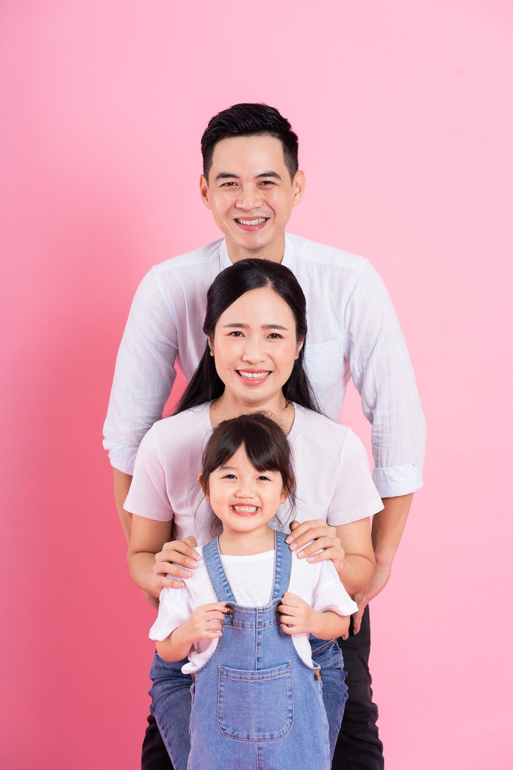 young asian family image isolated on pink background